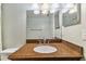 Bathroom featuring vanity with solid surface countertop, sink and mirror at 211 Somerset Cirle N, Dunedin, FL 34698