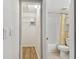 Hallway view of walk-in closet and bathroom; both providing storage and function at 211 Somerset Cirle N, Dunedin, FL 34698