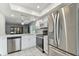 Bright, updated kitchen showcasing stainless steel appliances and a view into the living area at 211 Somerset Cirle N, Dunedin, FL 34698