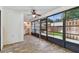 The sunroom has lots of light, wood-look tile, and a laundry area at 211 Somerset Cirle N, Dunedin, FL 34698