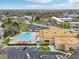 Aerial view of the condo community highlighting the swimming pool, parking area, and lush surroundings at 2400 Franciscan Dr # 34, Clearwater, FL 33763