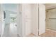 Hallway leading to a bathroom with a glass shower and a large window overlooking a green lawn at 2400 Franciscan Dr # 34, Clearwater, FL 33763