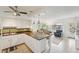 Bright kitchen features granite countertops, white cabinetry, modern appliances, a breakfast bar, and open access to the living area at 2400 Franciscan Dr # 34, Clearwater, FL 33763