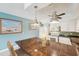 Bright kitchen features granite countertops, white cabinetry, modern appliances, and a center island with pendant lighting at 2400 Franciscan Dr # 34, Clearwater, FL 33763