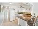 Bright kitchen features granite countertops, white cabinetry, modern appliances, and a center island with bar stool seating at 2400 Franciscan Dr # 34, Clearwater, FL 33763