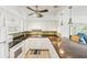 Bright kitchen features granite countertops, white cabinetry, mosaic backsplash, stainless steel appliances, and a breakfast bar at 2400 Franciscan Dr # 34, Clearwater, FL 33763