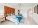Bright main bedroom features tile floors, a decorative wood accent wall, and a mirrored closet for added space at 2400 Franciscan Dr # 34, Clearwater, FL 33763