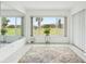 Bright sunroom with large windows offering views of the lush green lawn, complete with area rug at 2400 Franciscan Dr # 34, Clearwater, FL 33763