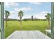 Beautiful view of the lush green golf course and palm trees seen from the balcony window at 2400 Franciscan Dr # 34, Clearwater, FL 33763