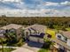 Home with pond and a beautiful backyard, surrounded by mature trees at 3150 Marine Grass Dr, Wimauma, FL 33598
