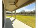 Covered patio for outdoor dining and entertaining overlooks the expansive fenced backyard at 3150 Marine Grass Dr, Wimauma, FL 33598