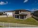 A beautifully fenced-in backyard offering a blend of privacy and charm for relaxation and entertainment at 3150 Marine Grass Dr, Wimauma, FL 33598