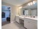 An open bathroom layout has double sinks and vanity adjacent to another room at 3150 Marine Grass Dr, Wimauma, FL 33598
