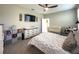 Cozy bedroom with ceiling fan, changing table, TV, and view of a Bedroom with a crib at 3150 Marine Grass Dr, Wimauma, FL 33598