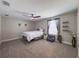 Bedroom with carpeted floors, ceiling fan, window, and a small seating area at 3150 Marine Grass Dr, Wimauma, FL 33598