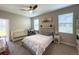This cozy bedroom boasts a ceiling fan, a comfortable bed, and a nearby crib at 3150 Marine Grass Dr, Wimauma, FL 33598