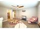 This well-lit Bedroom includes a ceiling fan, pink rocking chair, play mat, and closet at 3150 Marine Grass Dr, Wimauma, FL 33598