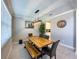 Elegant dining room with modern lighting, a large wooden table, and ample natural light at 3150 Marine Grass Dr, Wimauma, FL 33598