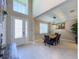Bright entryway featuring a high ceiling, large windows, and a view into the dining area at 3150 Marine Grass Dr, Wimauma, FL 33598