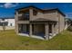 The exterior features a covered patio and balcony, great for outdoor living and entertaining at 3150 Marine Grass Dr, Wimauma, FL 33598
