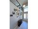 Inviting foyer with a gallery wall, tiled floors, and a staircase leading to the second floor at 3150 Marine Grass Dr, Wimauma, FL 33598