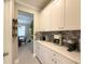 Modern kitchen with white cabinets, stainless steel appliances, and granite countertops at 3150 Marine Grass Dr, Wimauma, FL 33598