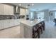 Modern kitchen featuring white cabinetry, stainless steel appliances, and a mosaic tile backsplash at 3150 Marine Grass Dr, Wimauma, FL 33598