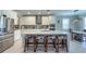 Bright kitchen with stainless steel appliances, quartz countertops, and island with seating at 3150 Marine Grass Dr, Wimauma, FL 33598