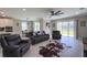 Comfortable living room with a ceiling fan and access to the kitchen and outdoor area at 3150 Marine Grass Dr, Wimauma, FL 33598