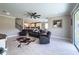 Inviting living room with tile floors, ceiling fan, and access to the kitchen and outdoor space at 3150 Marine Grass Dr, Wimauma, FL 33598