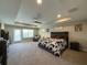 Relaxing main bedroom with a tray ceiling, ceiling fan, and plenty of natural light at 3150 Marine Grass Dr, Wimauma, FL 33598