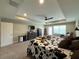 Spacious main bedroom with tray ceiling, ceiling fan, walk-out balcony, and comfortable decor at 3150 Marine Grass Dr, Wimauma, FL 33598