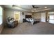 Comfortable main bedroom featuring a walk-in closet, en-suite bathroom, and modern furnishings at 3150 Marine Grass Dr, Wimauma, FL 33598