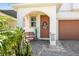 Charming front porch area with a bench and decorative details at 33846 Floating Heart Ct, Wesley Chapel, FL 33545