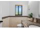 Stylish half-bathroom featuring a granite countertop, decorative tiles, and a window at 3460 Countryside Blvd # 19, Clearwater, FL 33761