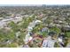 Aerial shot showing a property outlined in red, surrounded by lush greenery and other homes, with city skyline background at 3607 S Hubert Ave, Tampa, FL 33629