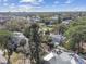 Aerial view of a home nestled in a tree-filled neighborhood with city views at 3607 S Hubert Ave, Tampa, FL 33629