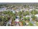 An aerial perspective showcases a property marked in red within a neighborhood filled with mature trees and diverse homes at 3607 S Hubert Ave, Tampa, FL 33629