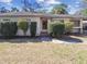 Charming home featuring a warm wooden front door, manicured shrubs and a walkway at 3607 S Hubert Ave, Tampa, FL 33629