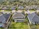 Aerial view of the home's backyard featuring a manicured lawn at 3667 Arbor Chase Dr, Palm Harbor, FL 34683