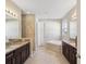 Spacious bathroom with double sinks, granite countertops and soaking tub at 3667 Arbor Chase Dr, Palm Harbor, FL 34683