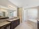 Bathroom with double vanity, granite countertop and soaking tub at 3667 Arbor Chase Dr, Palm Harbor, FL 34683