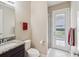 Powder room features granite countertop and walk-in shower at 3667 Arbor Chase Dr, Palm Harbor, FL 34683