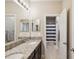 Well-lit bathroom with double sinks, granite countertop, and a separate shower area at 3667 Arbor Chase Dr, Palm Harbor, FL 34683