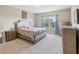 Bright bedroom with neutral decor and large window at 3667 Arbor Chase Dr, Palm Harbor, FL 34683