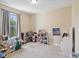 Bright bedroom featuring neutral walls, a large window, and plenty of space for play at 3667 Arbor Chase Dr, Palm Harbor, FL 34683