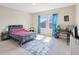 Cozy bedroom featuring a comfortable bed, blue rug, and a desk area perfect for study or work at 3667 Arbor Chase Dr, Palm Harbor, FL 34683