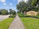 Arbor Chase entrance sign surrounded by lush greenery, showcasing community pride at 3667 Arbor Chase Dr, Palm Harbor, FL 34683