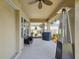 Inviting covered patio with a ceiling fan, outdoor seating, and a heater for year-round enjoyment at 3667 Arbor Chase Dr, Palm Harbor, FL 34683