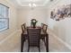Formal dining room with an elegant table set, chandelier, and window for natural light at 3667 Arbor Chase Dr, Palm Harbor, FL 34683